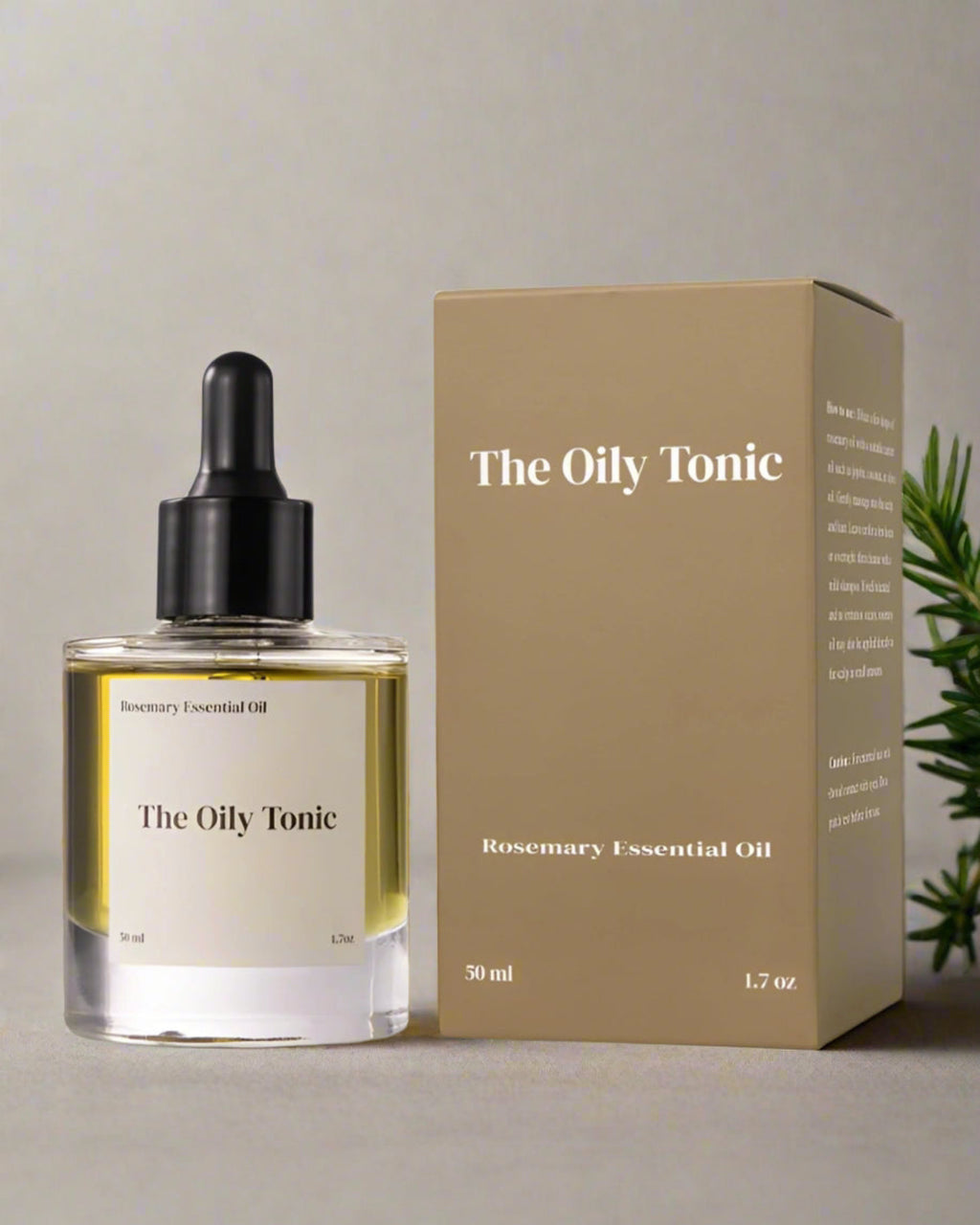 The Oily Tonic rosemary essential oil bottle and packaging on a white background